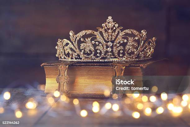 Low Key Image Of Decorative Crown On Old Book Stock Photo - Download Image Now - Princess, Tiara, Crown - Headwear