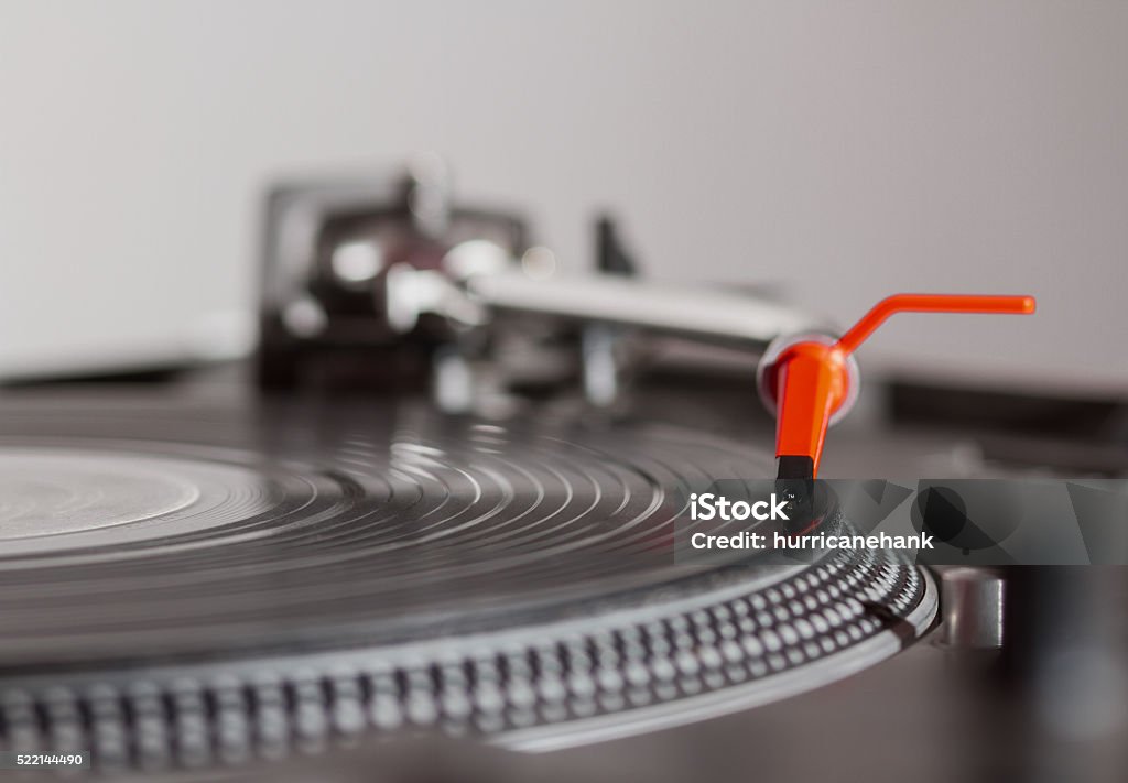 Turntable playing vinyl record with music Turntable playing vinyl record with music. Close up, macro photo. Professional audio equipment for DJ, nightclub or audio enthusiast. Arts Culture and Entertainment Stock Photo