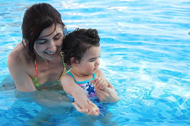 istock baby and mother in swimming pool 522145614