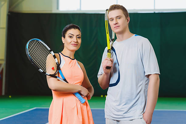 istock Two Happy smiling Tennis Players posing indoor 522145656