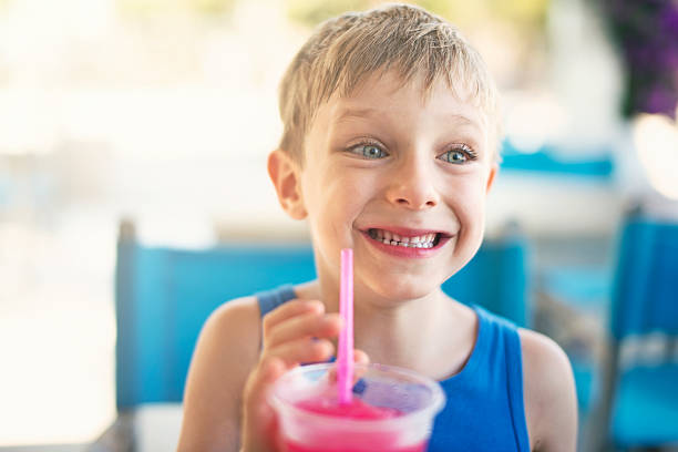 istock Little boy drinking soda with crushed ice on summer day 522147496
