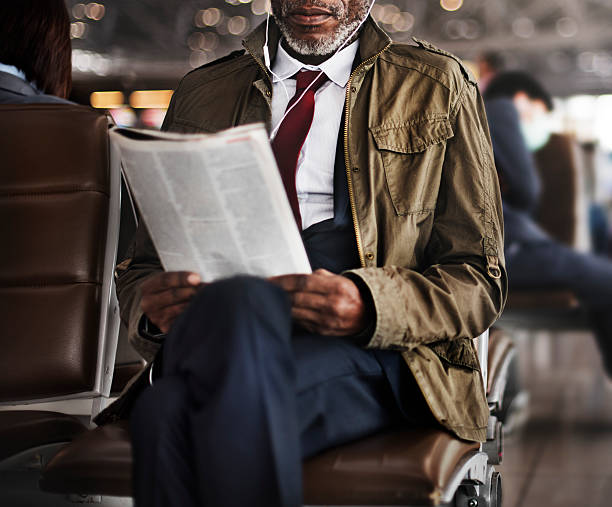 African Business Concentration Reading Concept African Business Concentration Reading Concept newspaper airport reading business person stock pictures, royalty-free photos & images