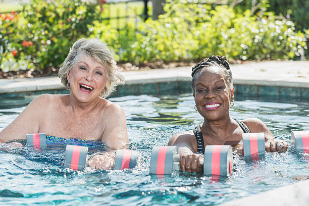 istock Senior women in pool doing water aerobics 522147886