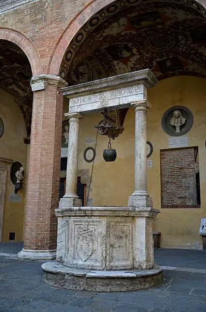 Photo of Renaissance courtyard with a well, Siena