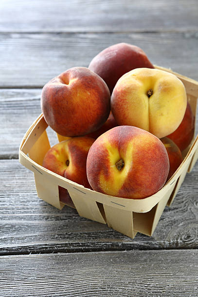 istock Juicy and fragrant peaches in  box 522151681