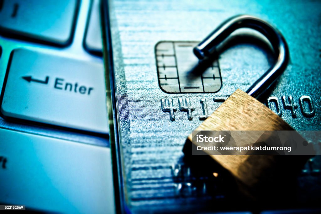 credit card data security Open security lock on credit cards with computer keyboard / Credit card data breach White Collar Crime Stock Photo