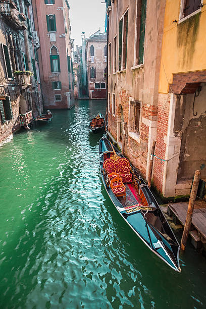 istock Beautiful gondolas on a canal in Venice 522152595