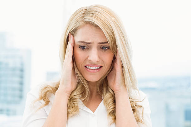 istock Young businesswoman with headache 522154245