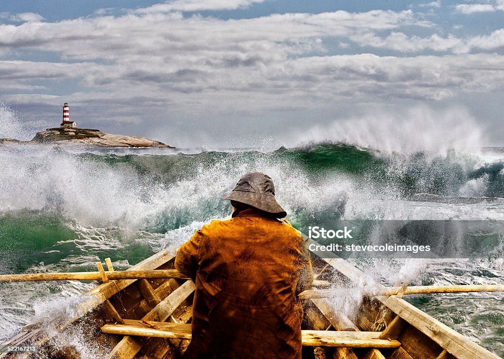 Old man and the Sea in a Skiff Old man and the sea in a rowboat or skiff paddling and fighting the waves of the ocean. Storm Stock Photo