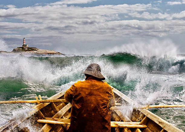 Old man and the Sea in a Skiff Old man and the sea in a rowboat or skiff paddling and fighting the waves of the ocean. beacon photos stock pictures, royalty-free photos & images