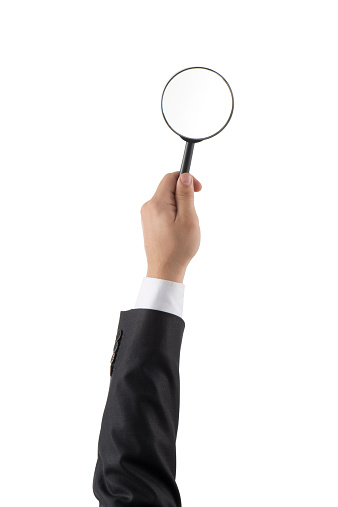 businessman arm holding a Magnifying Glass (Clipping path)