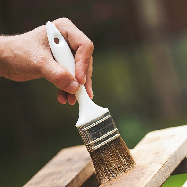 istock Man painting a wooden deck 522169575