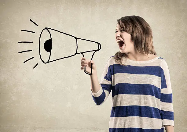 Photo of Teenage Girl, shouting in a Megaphone