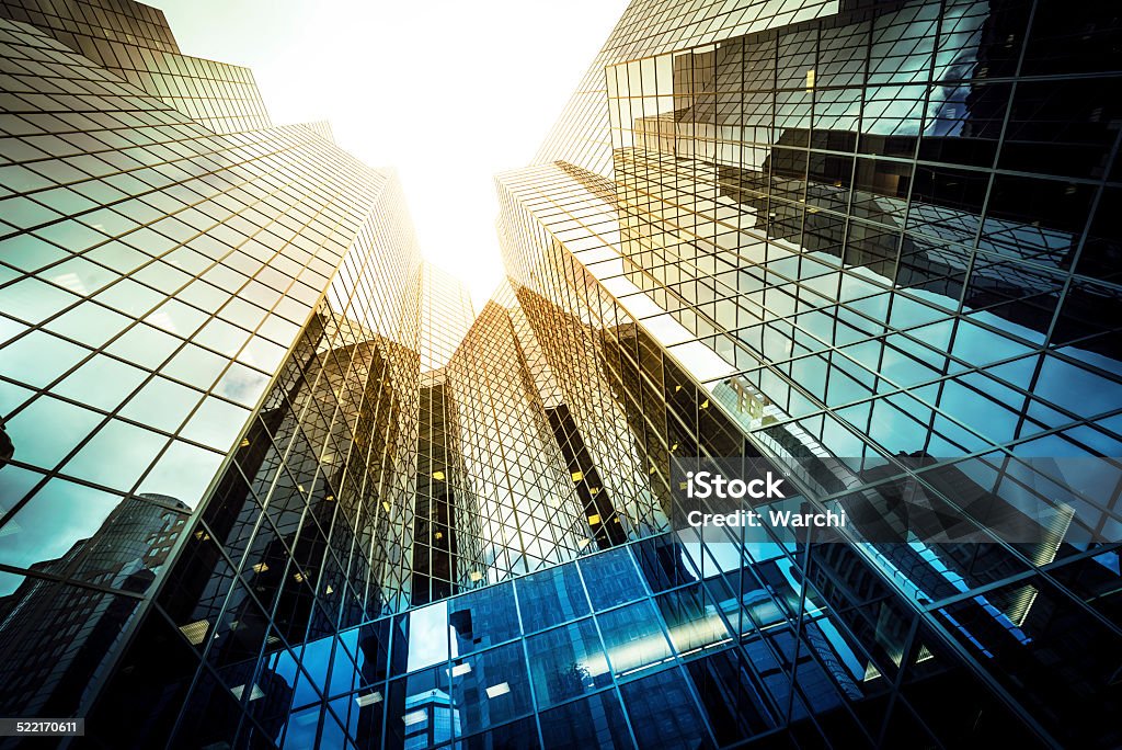 Modern glass office building Modern glass office building wide angle view looking up Abstract Stock Photo