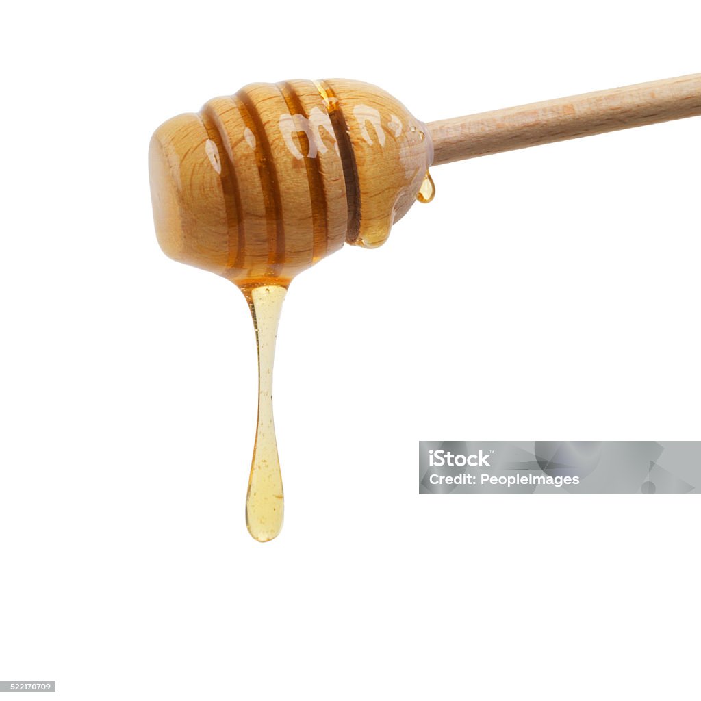 Food of the gods Closeup shot of a honey spoon dripping delicious honey Alternative Medicine Stock Photo