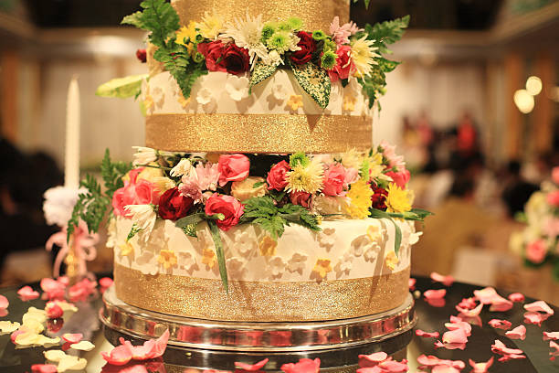 A group of beautifully iced and decorated gateaux on display in a bakery.
