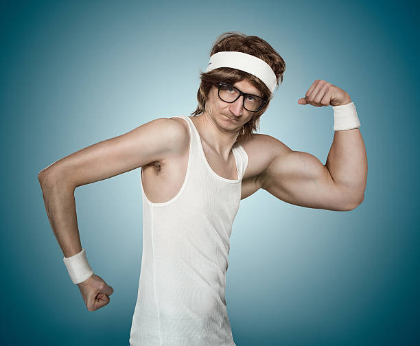 witzige retro macho mann - flexing muscles stock-fotos und bilder