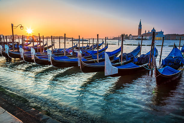 istock Blue gondolas at sunrise in Venice 522171707