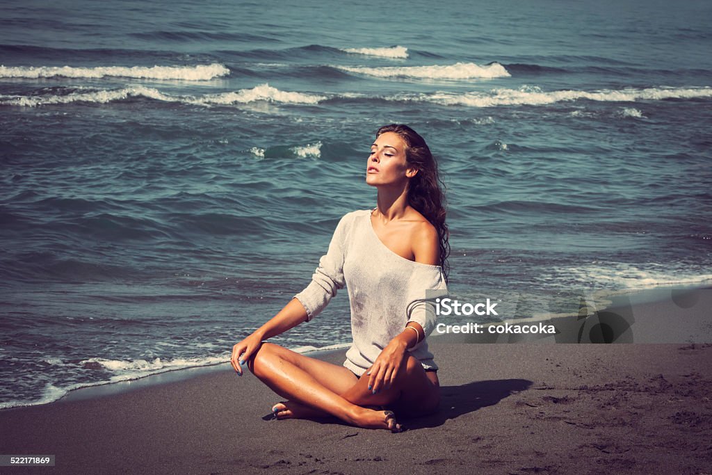 summertime relax young woman enjoy in sun on sandy beach by the sea full body shot Adult Stock Photo