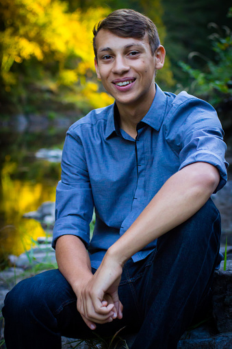 Young Man Sitting By The River