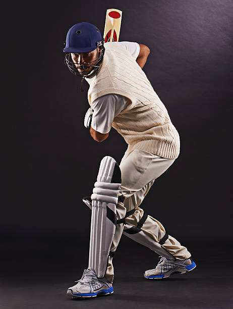 The perfect strike A cropped shot of an ethnic young man in cricket attire isolated on black cricket player stock pictures, royalty-free photos & images