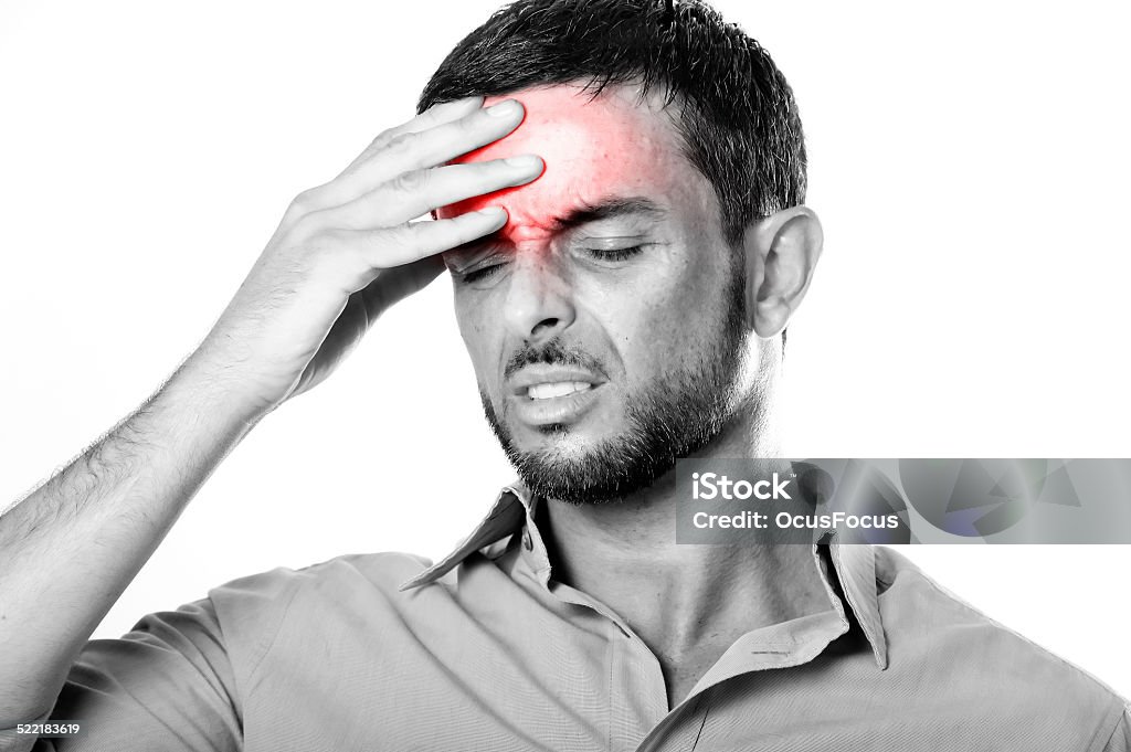 Young Man suffering Headache and migraine in pain expression Young attractive Man with Beard suffering Headache and migraine in pain and ache face expression Isolated on White Background touching his head with red color on ache area Adult Stock Photo