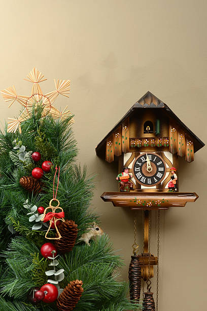 A cute little rodent has climbed the Christmas tree to peek out at the cuckoo clock as it strikes midnight on Christmas Eve.