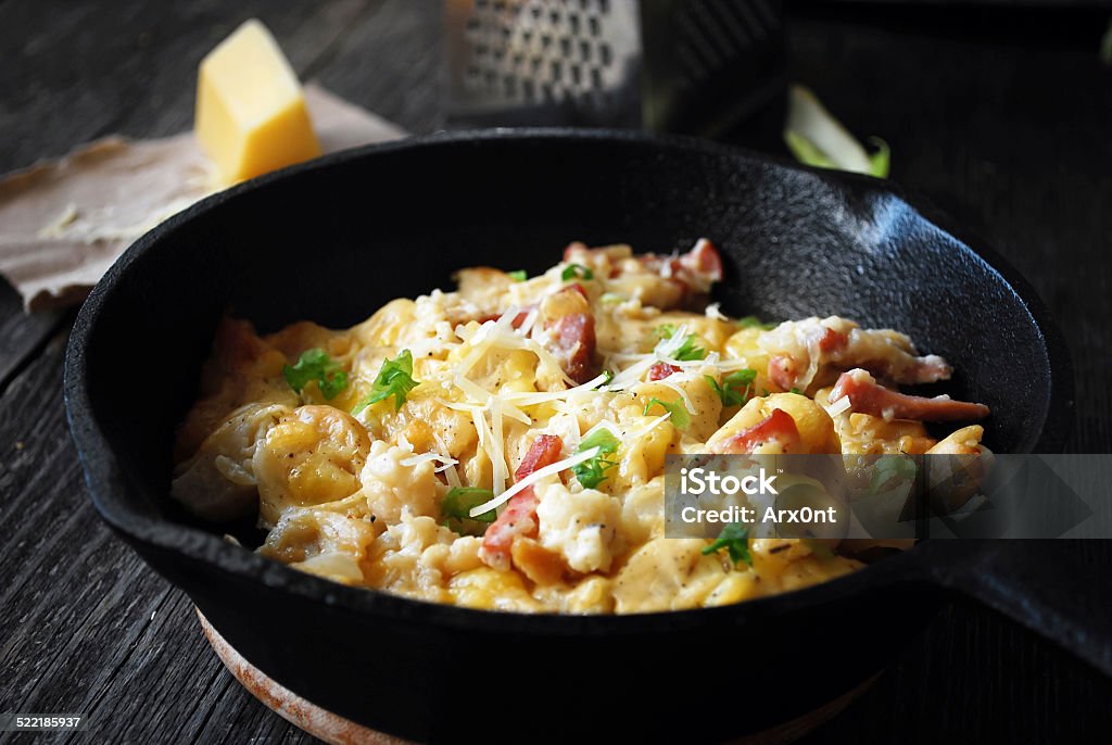 Cauliflower gratin with bacon Fragrant warm cauliflower gratin with bacon and three cheeses served in rustic iron skillet Cauliflower Stock Photo