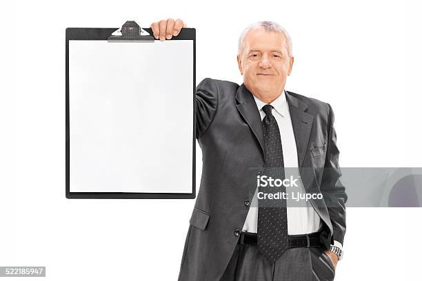 Mature Man In Formalwear Holding A Clipboard Stock Photo - Download Image Now - 50-59 Years, Active Seniors, Adult