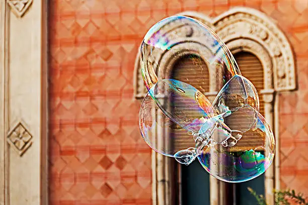 Giant soap bubbles on a background of historic building.