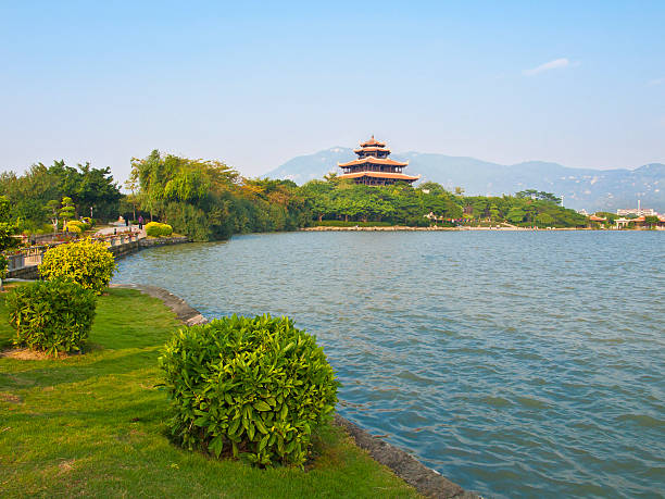 temple near lake asian temple at west lake park, quanzhou, fujian, china west lake stock pictures, royalty-free photos & images