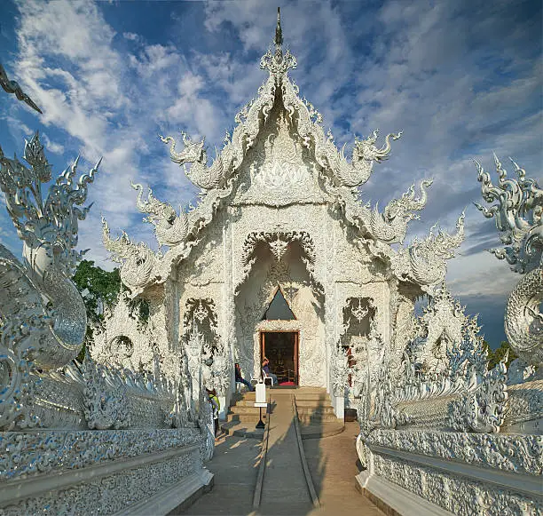 Beautiful ornate white temple located in Chiang Rai northern Thailand. Wat Rong Khun (White Temple), is a contemporary unconventional Buddhist temple.Buddhist and Hindu motifs.