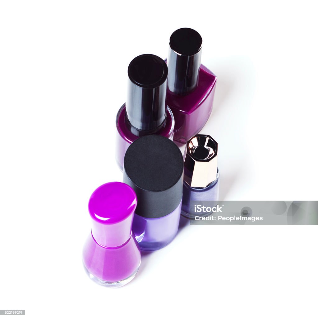 Add some purple into your beauty Studio shot of colorful nail varnish bottles Abstract Stock Photo