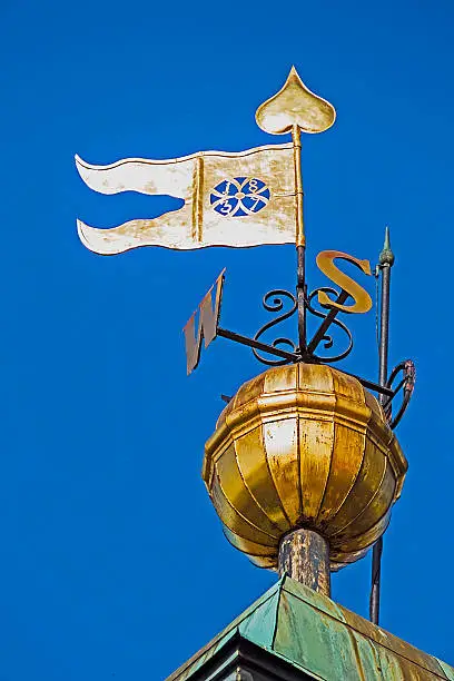 Metal signs with cardinal points and flag, placed on the clock tower in Novi Sad, to be visible for sailors.
