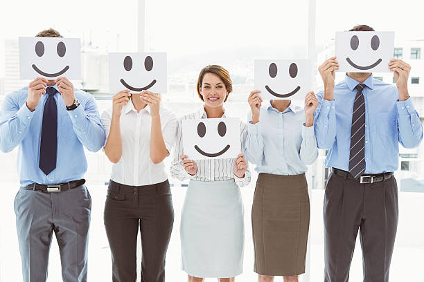 istock Business people holding happy smileys 522189757