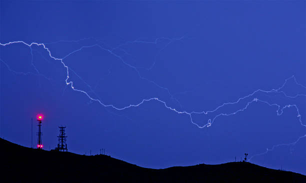istock lightning bolt with communication towers 522190173