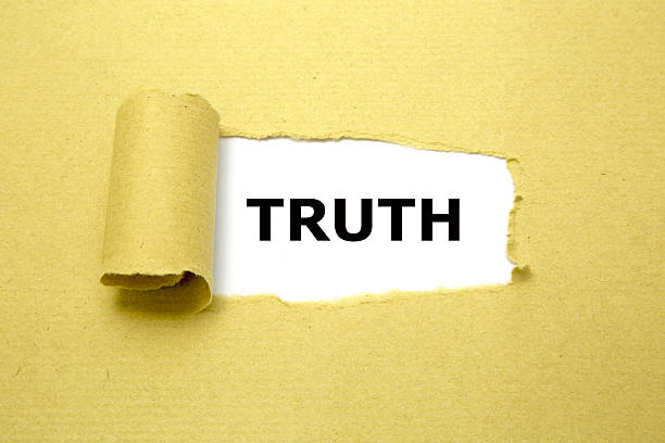 istock Truth appearing behind torn brown paper. 522198803