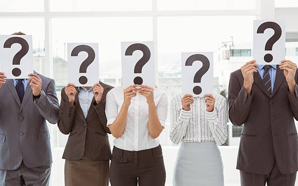 istock Business people holding question mark signs in office 522199043