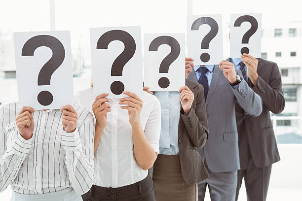 istock Business people holding question mark signs in office 522199171
