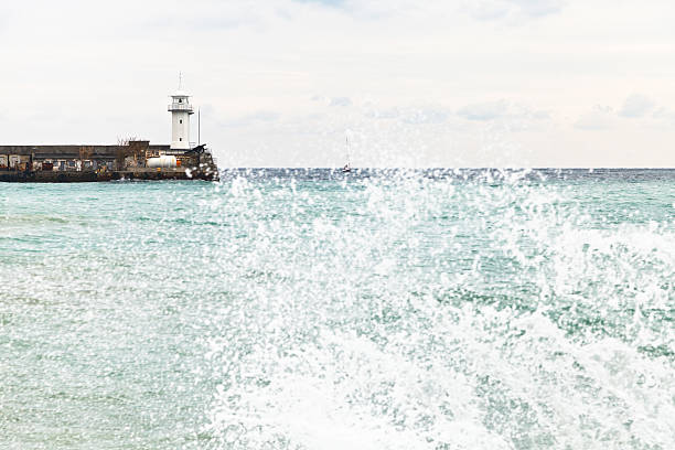 wharf with lighthouse in Yalta city in autumn day, Crimea