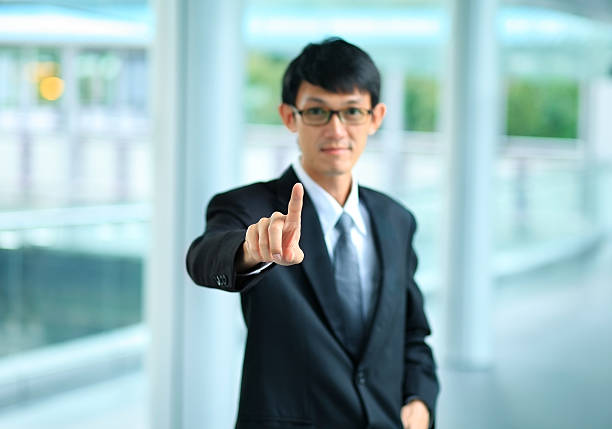 istock young business man in a suit pointing with his finger 522200717