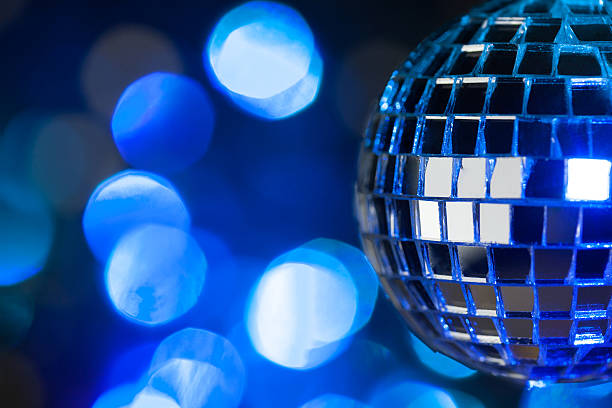 istock Beautiful disco ball on dark bokeh background 522200955