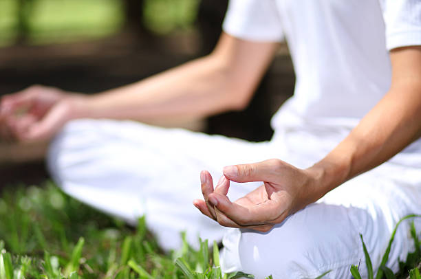 istock Young man during relaxation and meditation in park meditation se 522202125