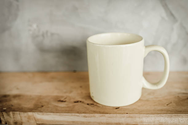 istock Dirty White coffee cup on wooden shelf against grey background. 522203533