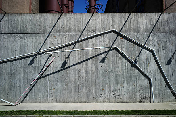 drain pipes and lam shadows at concrete wall in turkey