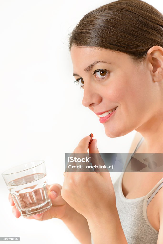 Taking a Pill A woman taking a pill isolated on white Acetylsalicylic Acid Stock Photo