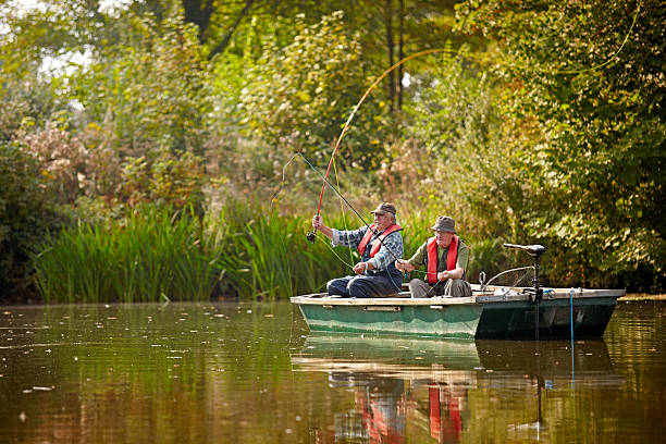 dois seniors num lago de pesca - fishing nautical vessel small men imagens e fotografias de stock