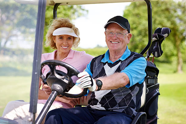 istock Senior couple driving a golf cart 522220683