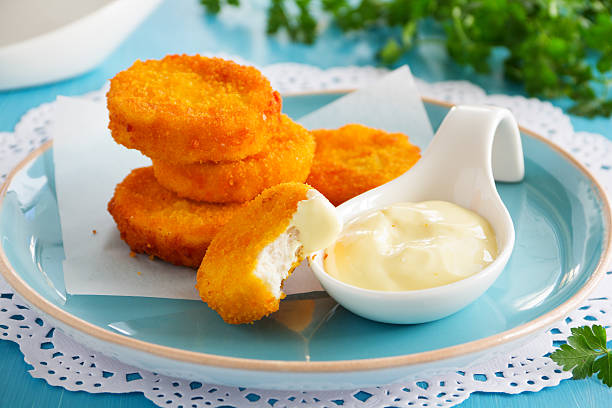 istock Homemade chicken nuggets with cheese sauce. 522221017