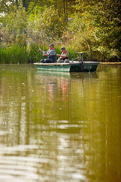 istock Two mature men fishing on a lake 522222371
